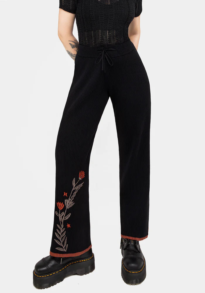 Joggers de punto con bordado floral naranja y marrón en la pierna
