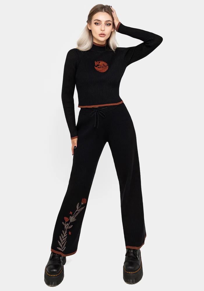 Joggers de punto con bordado floral naranja y marrón en la pierna