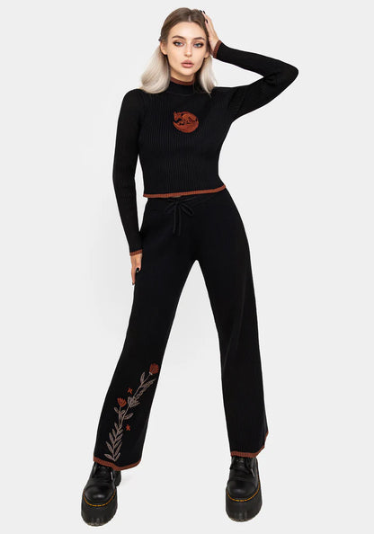 Joggers de punto con bordado floral naranja y marrón en la pierna