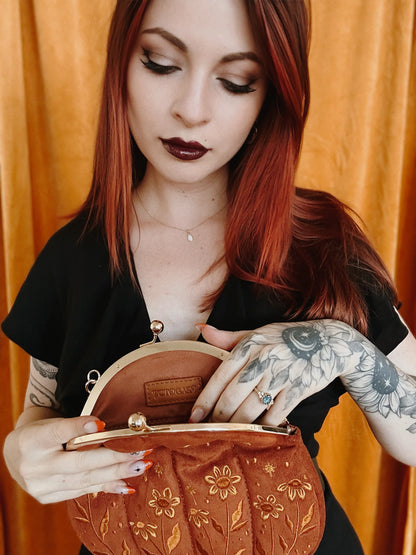 Bolso de terciopelo bordado con forma de calabaza en color negro.